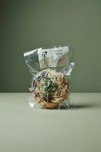 Packaged Frozen Vegan Miso Ramen with visible toppings such as ground tofu, mushrooms, and scallions.